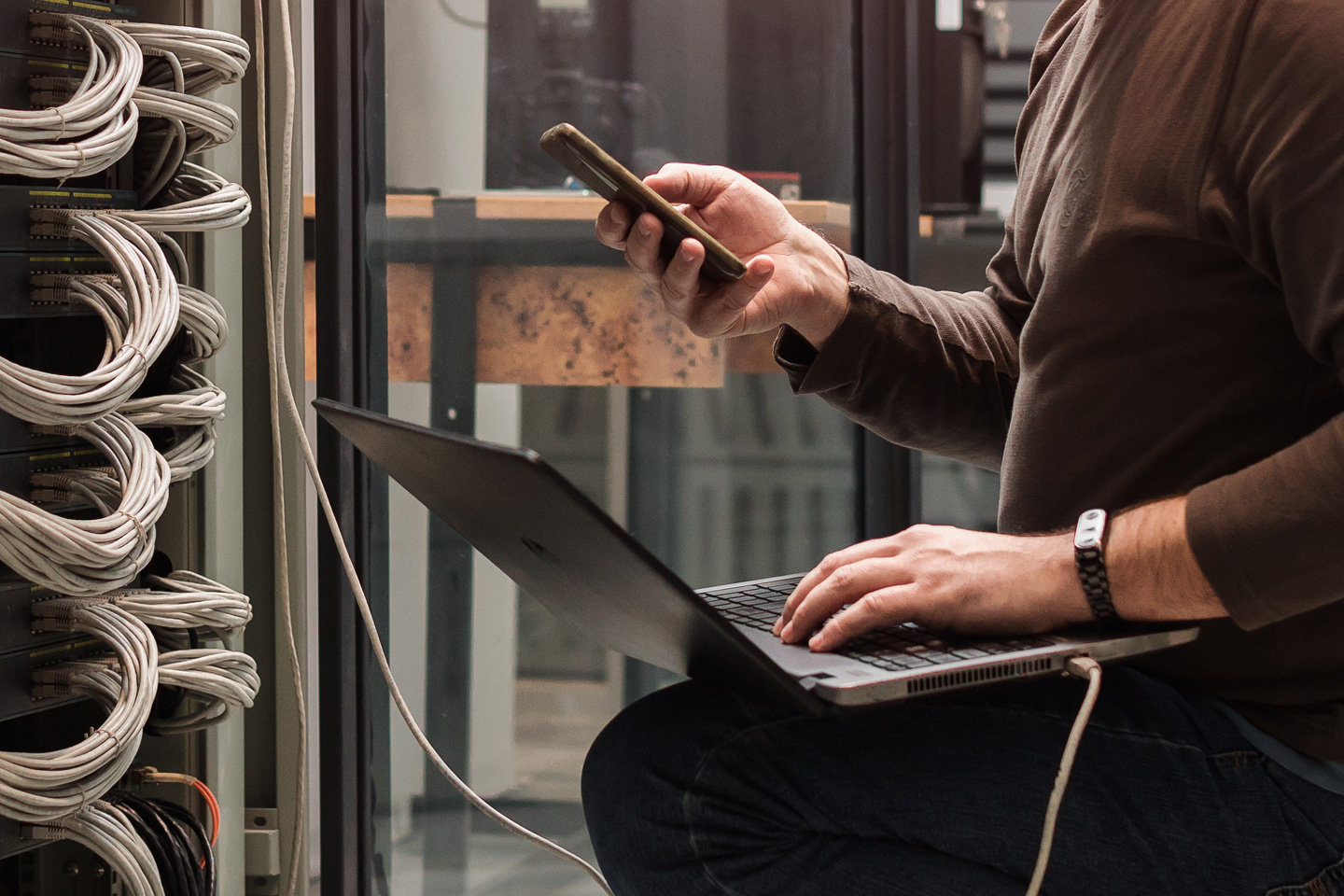 image of person using a laptop and phone