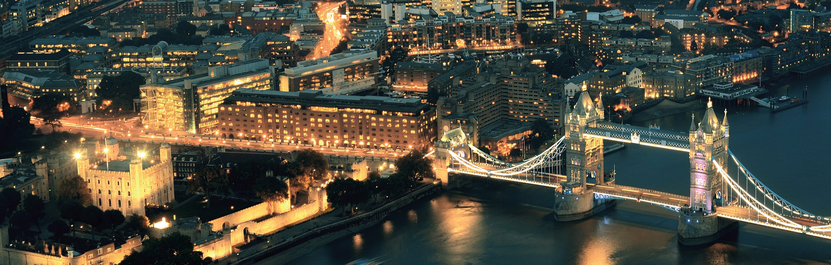 aerial image of a city and a bridge at night