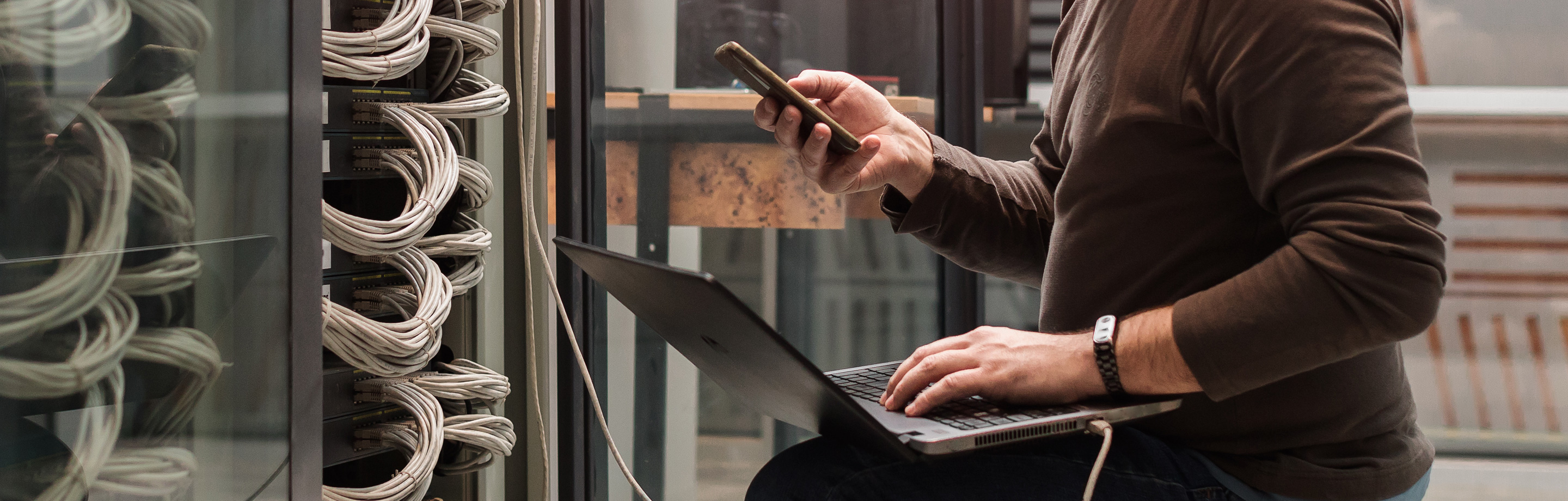 ban checking phone whilst on his laptop